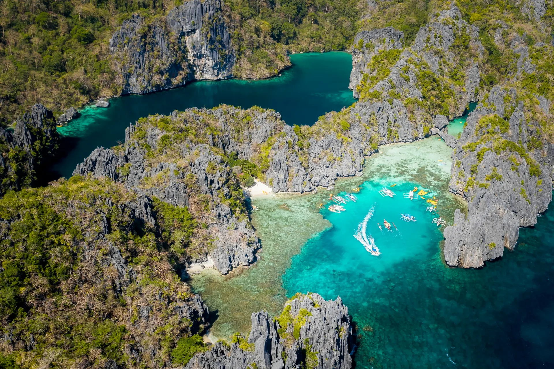 Aerial photograph of Big Lagoon and Small Lagoon in El Nido, Palawan, with limestone cliffs and turquoise water.