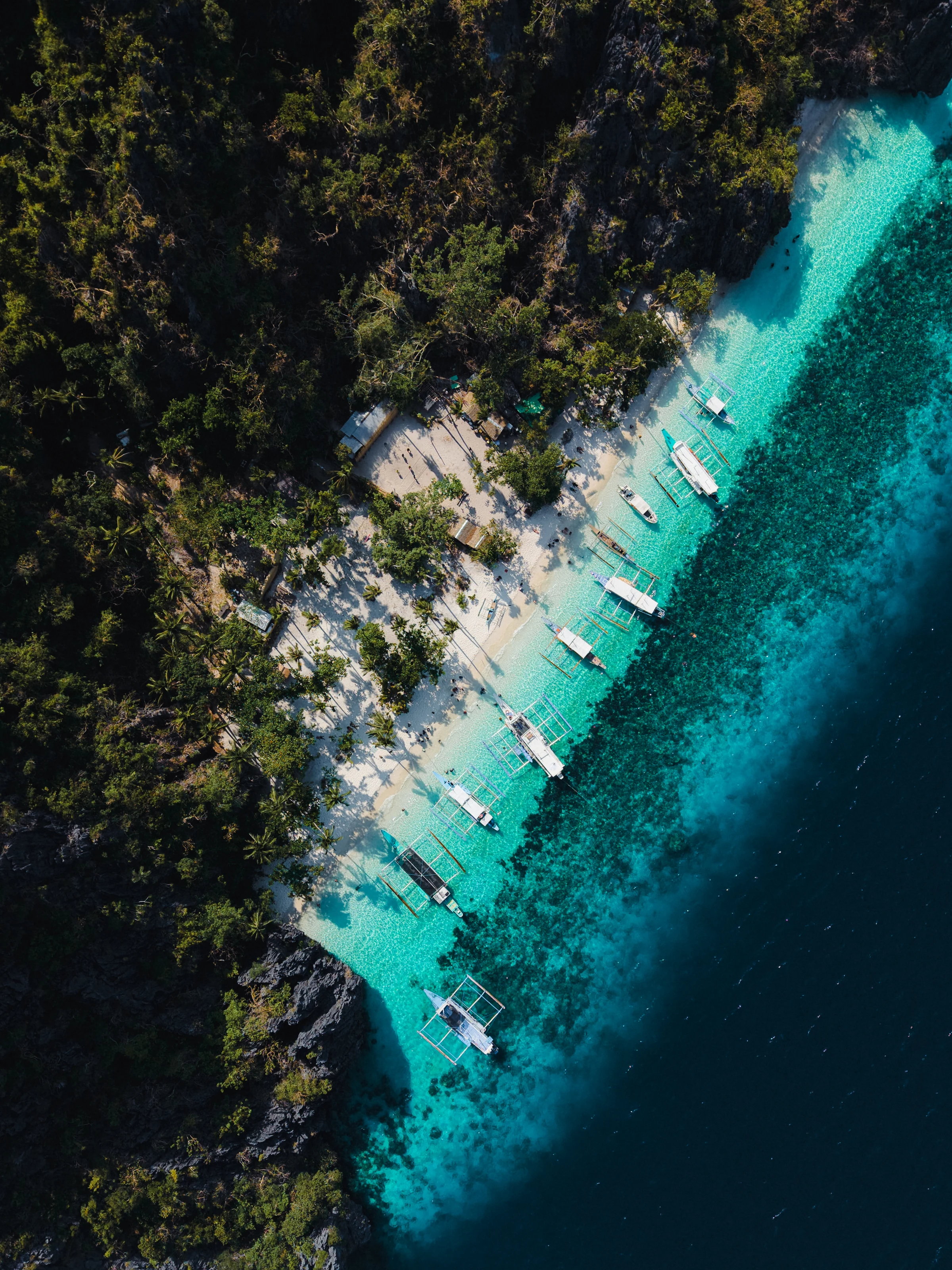 Aerial photograph of Entalula Beach in El Nido, with white sand, boats and turquoise water